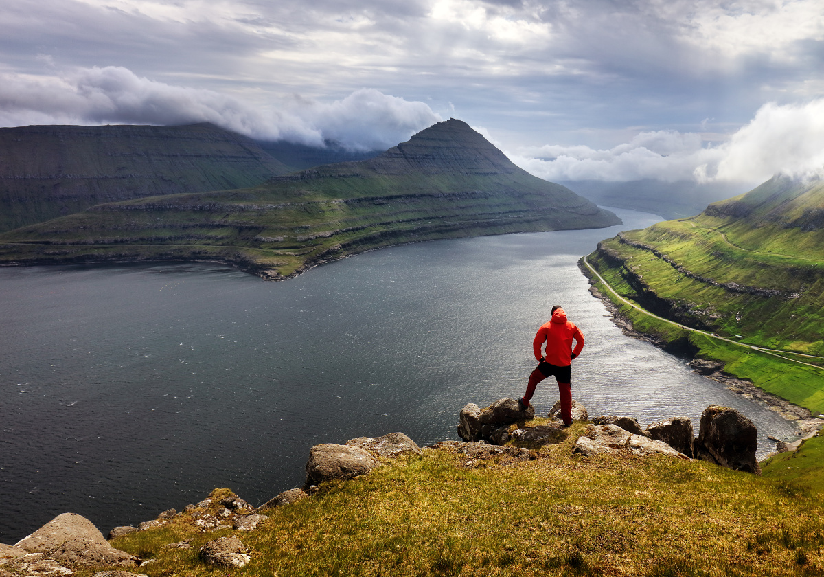 Tourist looking over majestic fjords - Funningur